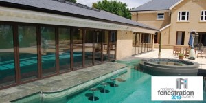 A 9 door + 7 door set of Origin bi-fold doors installed into an indoor outdoor pool extension.